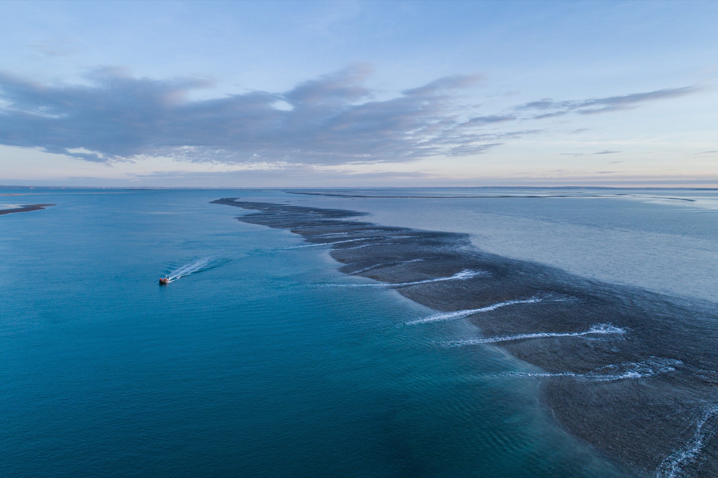 A long long streak of ocean, darkened by the reef underneath