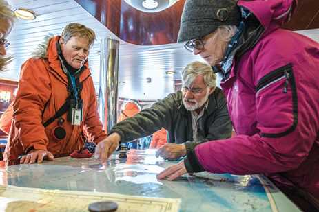 Exploring maps in the National Geographic Explorer's chart room