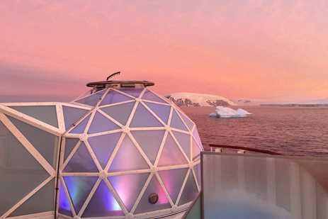 Geodesic glass igloo overlooks Antarctic landscape